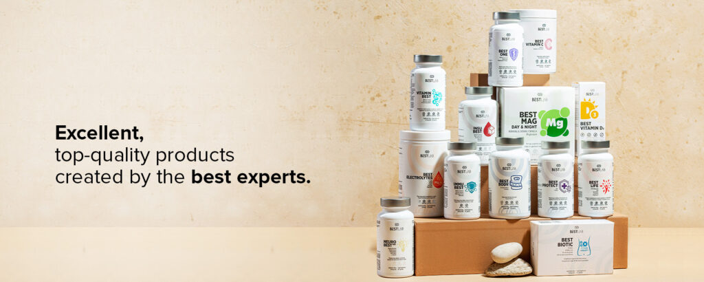 A pyramid display of white supplement bottles and boxes on wooden blocks, labelled with various health benefits, next to text reading “Excellent, top-quality products created by the best experts.”. UK