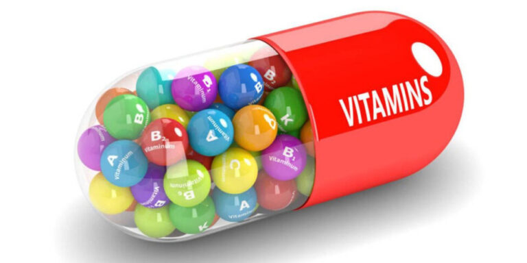 a large red capsule labelled vitamins is filled with colourful spheres, each labelled with different vitamin letters such as a, b, c, d, e, and k, symbolising a variety of vitamins inside a pill. uk