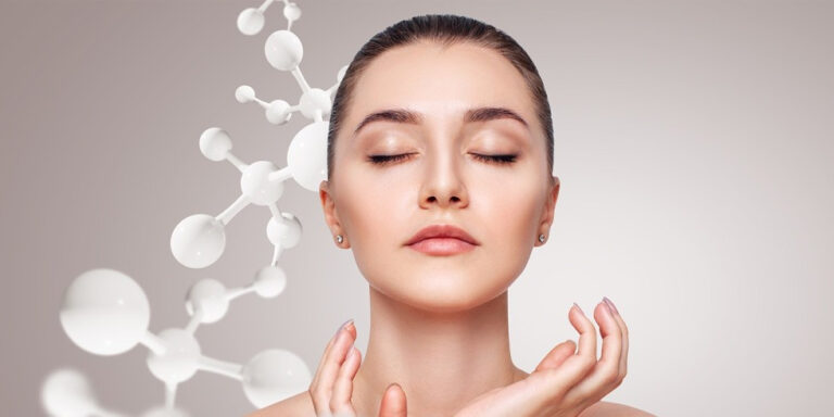 a woman with closed eyes and hands gently touching her chin stands in front of a neutral background, with white molecular structures floating beside her, suggesting skincare or beauty science. uk